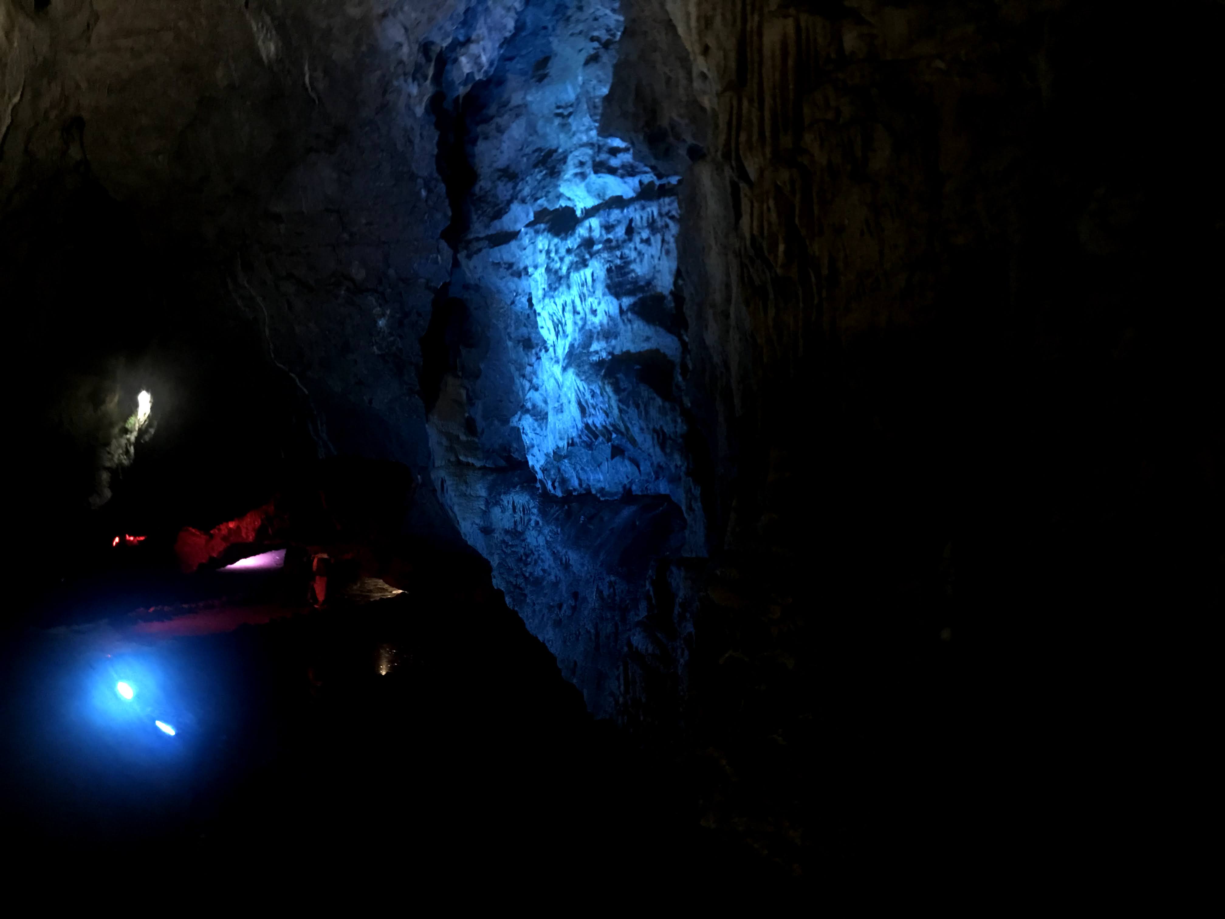 A cave being illuminated with blue lighting/